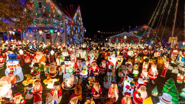 Peckville Christmas House with illuminated holiday lights and lighted toy displays at night.