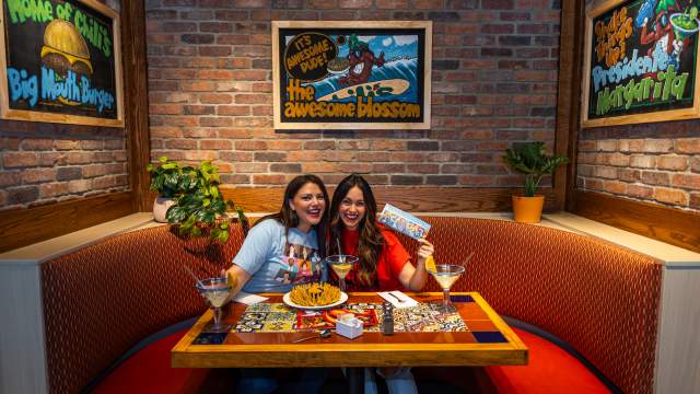 Womans getting photo taken at the awesome blossom photo booth table at Chili's Grill & Bar in Dickson City, PA