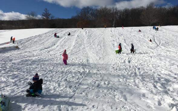 kids sleigh riding at McDade Park