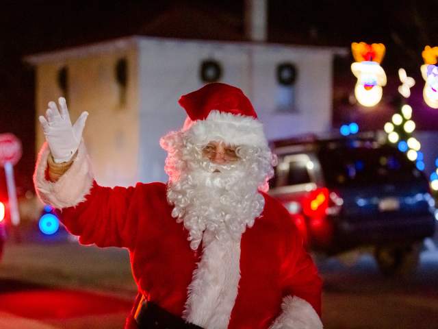 Santa Claus greeting families at Nay Aug Park holiday lights event