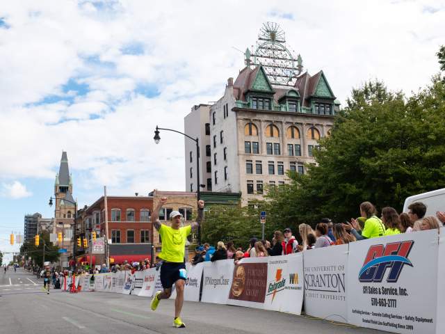 A runner finishing the Steamtown Marathon in Downtown Scranton, PA