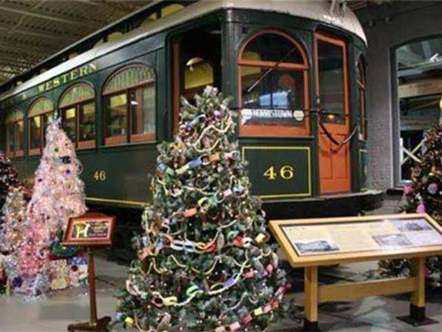Christmas trees in front of an antique trolley at the Electric City Trolley Station & Museum, in Scranton, PA.