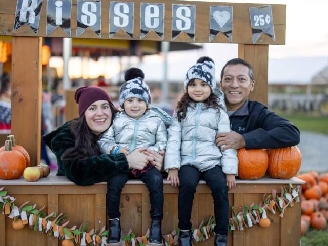 A family posing at the kissing booth at Lakeland Orchard & Cidery in Scott Township, PA