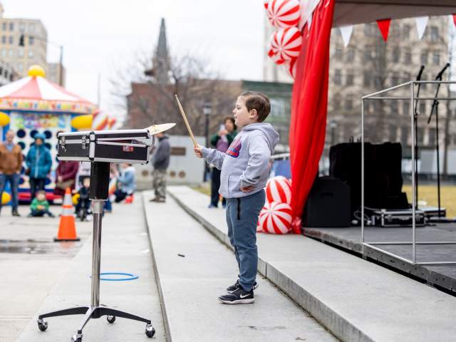 Child playing a drum at Downtown On Ice in Downtown Scranton, PA