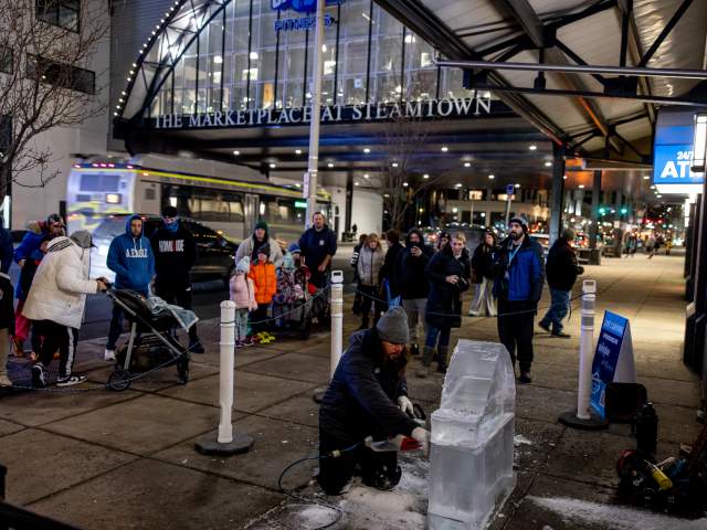 A crowd watching an ice sculpture being created at the Downtown on Ice event in Downtown Scranton, PA