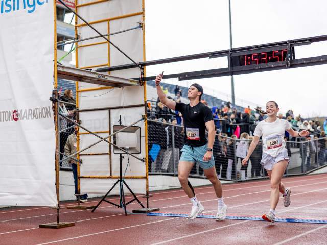 Race participants taking selfie while crossing the finish line at the Scranton Half Marathon