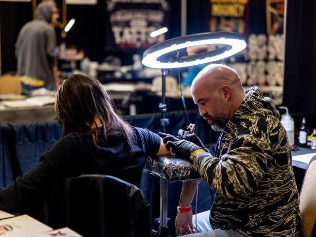A woman getting tattooed at the Electric City Tattoo Convention at the Hilton Scranton & Conference Center in Downtown Scranton, PA