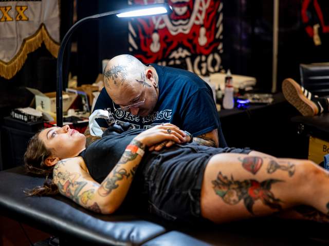 A woman getting tattooed at the Electric City Tattoo Convention at the Hilton Scranton & Conference Center in Downtown Scranton, PA
