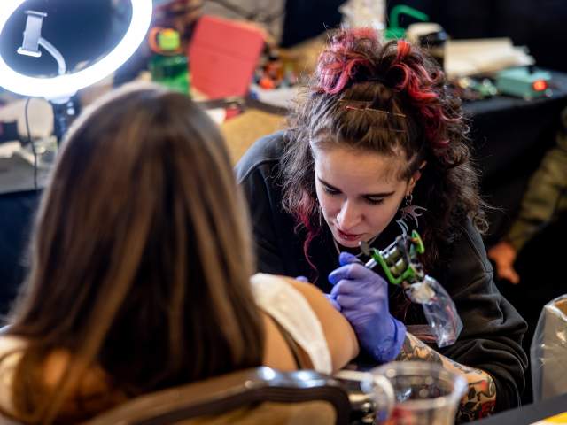 A woman getting tattooed at the Electric City Tattoo Convention at the Hilton Scranton & Conference Center in Downtown Scranton, PA