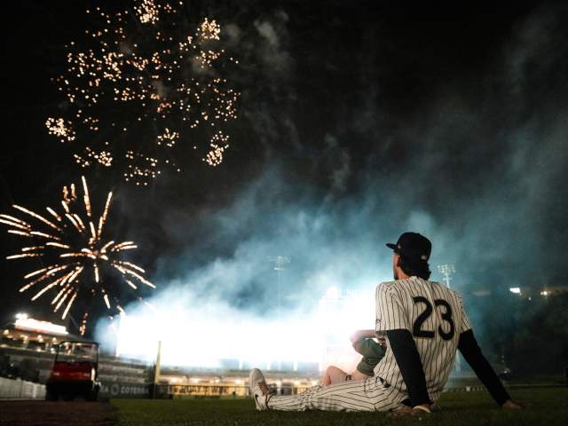 A SWB RailRiders baseball player watching post-game fireworks