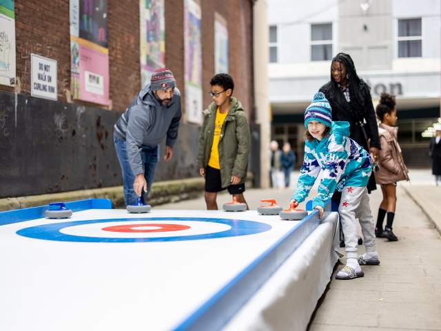 Playing curling at Downtown on Ice