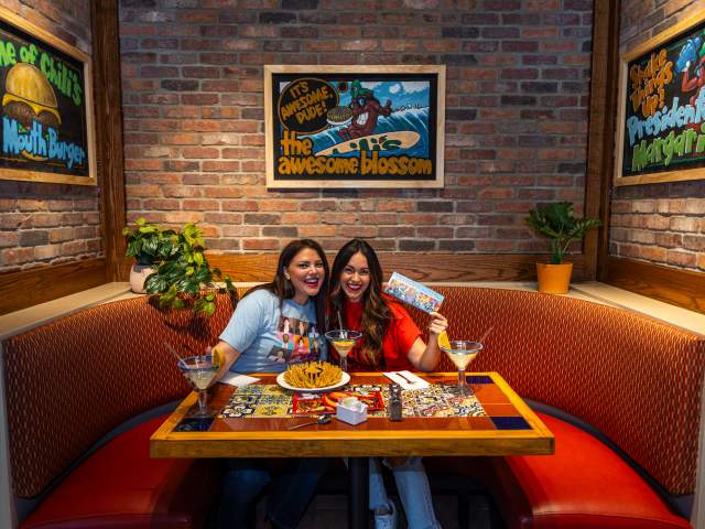 Womans getting photo taken at the awesome blossom photo booth table at Chili's Grill & Bar in Dickson City, PA