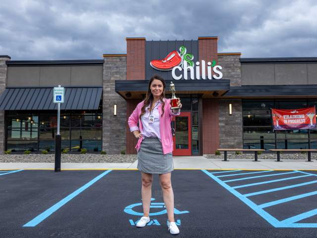 Woman dressed as Pam Beesly standing in front of Chili's Grill & Bar in Dickson City, PA