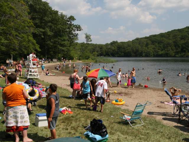 People on the beach and swimming at Merli-Sarnoski Park