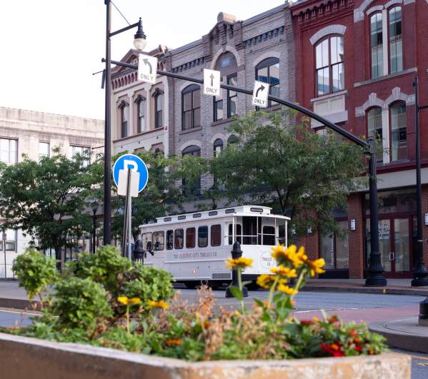 The Electric City Trolley Co trolley bus driving down a street in Downtown Scranton