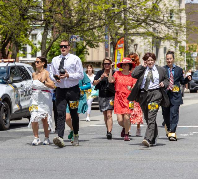 Participants dressed in costumes running down the street in The Office 5K in Scranton, PA