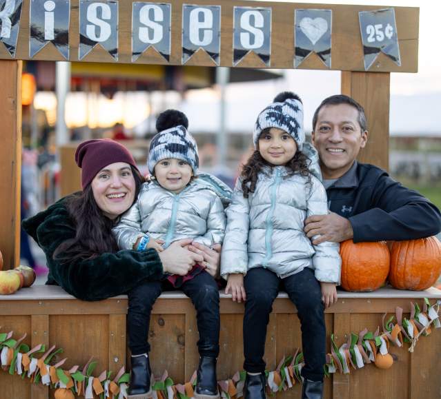 A family posing at the kissing booth at Lakeland Orchard & Cidery in Scott Township, PA