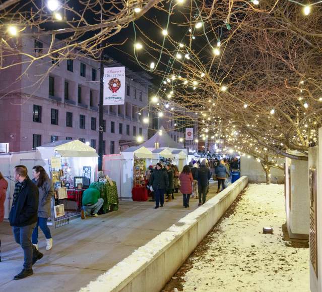 Holiday lights, shoppers, and vendors at the Lackawanna Winter Market in downtown Scranton, PA