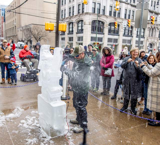 A man carving an ice block at Downtown on Ice in Downtown Scranton, PA