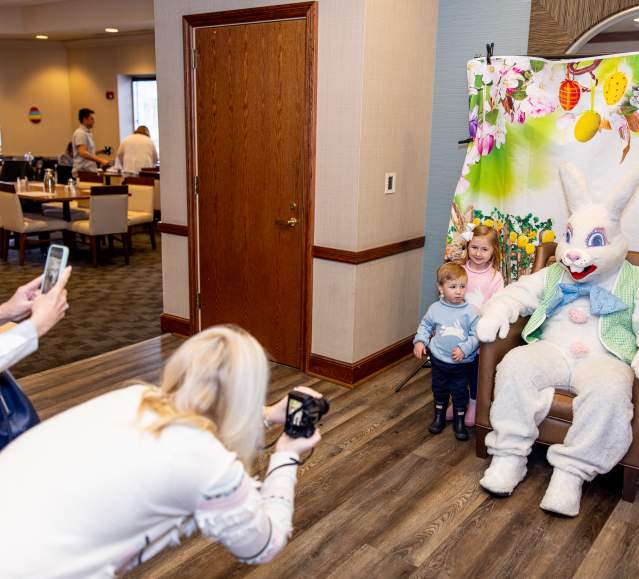 Parents taking photos of their children with the Easter Bunny at the Hilton Scranton & Conference Center.