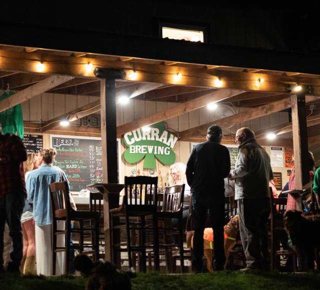 People enjoying drinks at Curran Brewing in Madison Township, PA