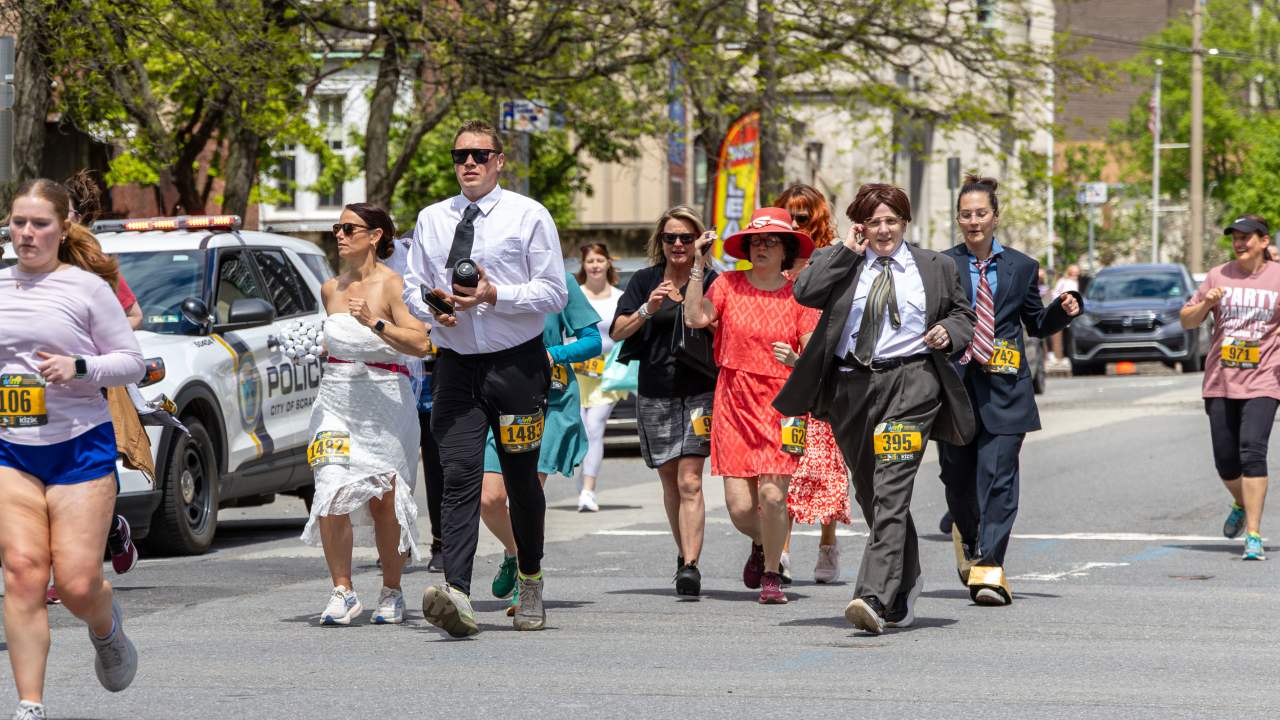 Participants dressed in costumes running down the street in The Office 5K in Scranton, PA