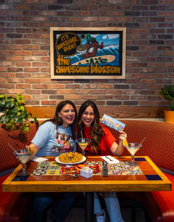 Womans getting photo taken at the awesome blossom photo booth table at Chili's Grill & Bar in Dickson City, PA