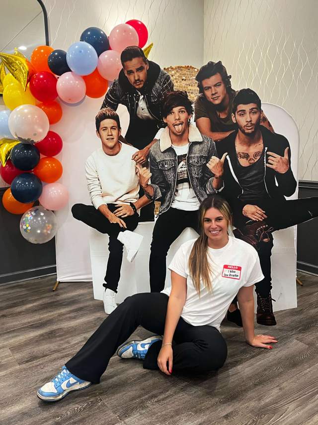 Mattia Krappa owner of Lucca Fresca, standing with One Direction cutouts