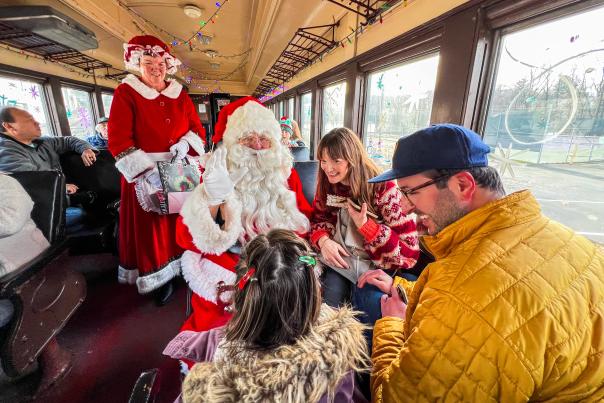 Santa and Mrs. Claus visiting with a family on the North Pole Limited train ride at the Steamtown National Historic Site in Downtown Scranton, PA