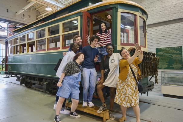 A group of people taking a selfie on a trolley car at the Electric City Trolley Station & Museum in Downtown Scranton, PA