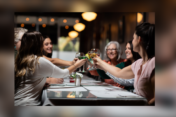 Women raising cocktails in a cheerful toast inside Alfredo’s Café in Scranton, PA.