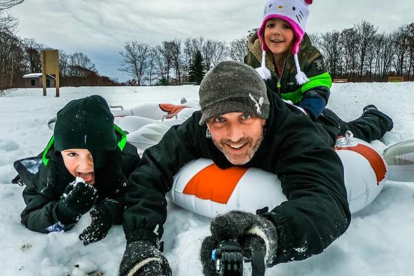 dad and 2 kids snow tubing at Aylesworth Park