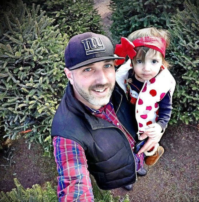 Father and daugther at the Christmas Tree Farm at Lakeland Orchard & Cidery