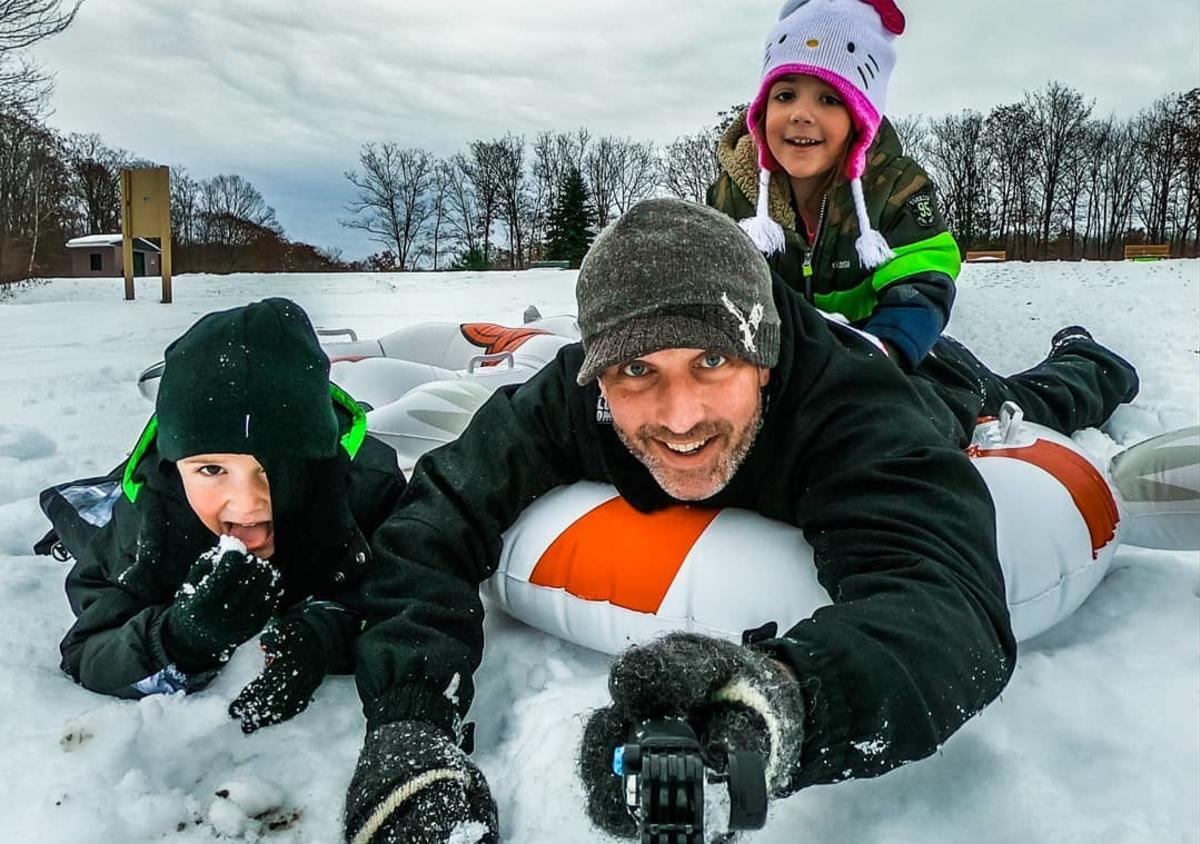 dad and 2 kids snow tubing at Aylesworth Park