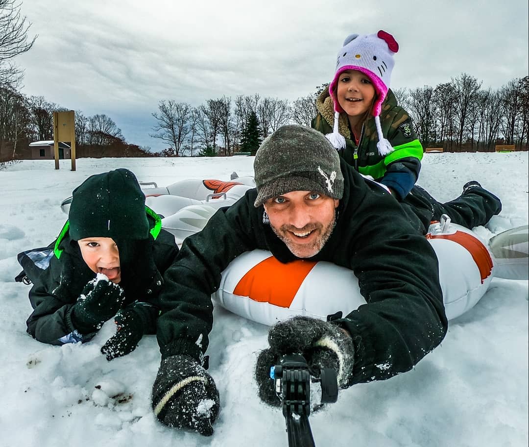 dad and 2 kids snow tubing at Aylesworth Park