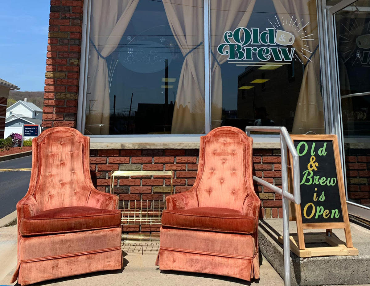 Two vintage chairs in front of the entrance of Old & Brew in Peckville, PA