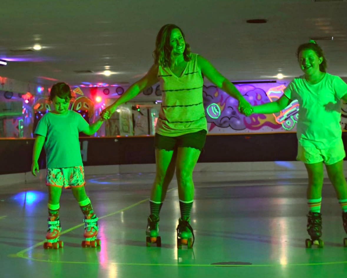 A family rollerskating at The Rink at Mayfield in Mayfield, PA