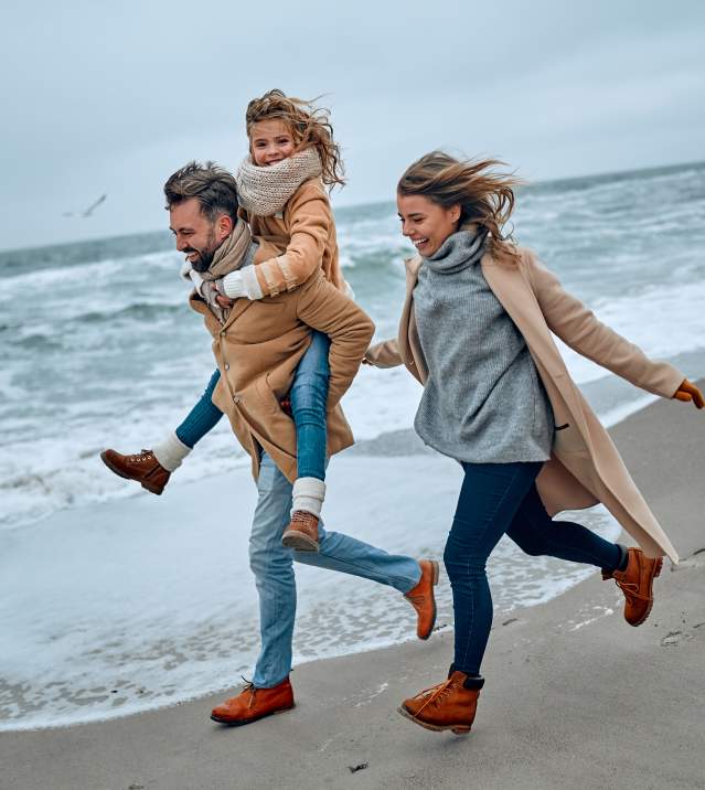 Family on beach in the winter