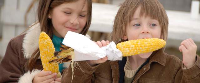 Kids eating corn