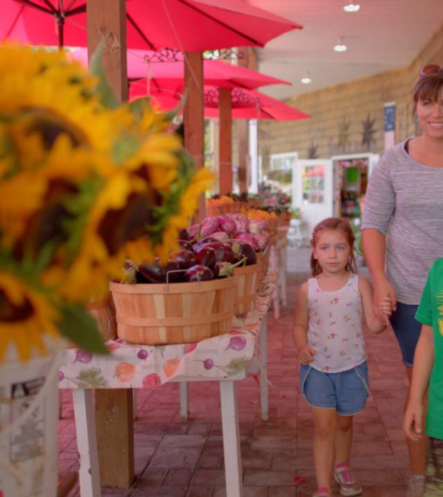 Mother and kids shopping for Local Produce