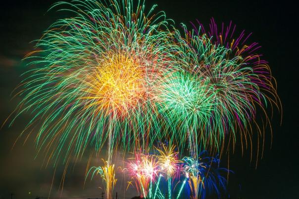 Different color fireworks going off at night