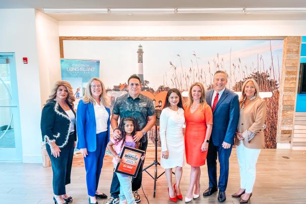 group of people standing in front of lighthouse picture