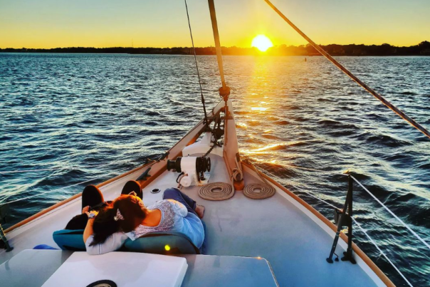 couple on a boat watching the sunset on the water