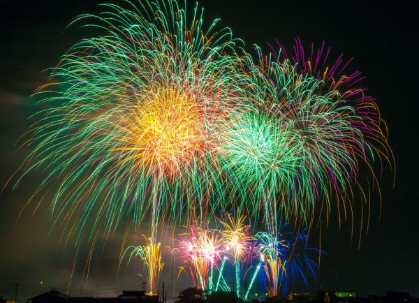 Different color fireworks going off at night