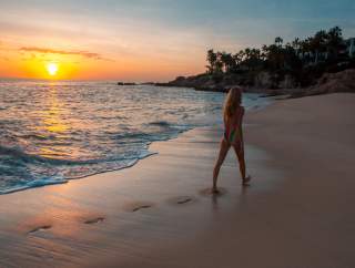 Woman Walking on Beach