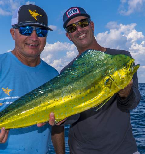 Two men holding Up a Mahi Mahi fish in Panama City Beach