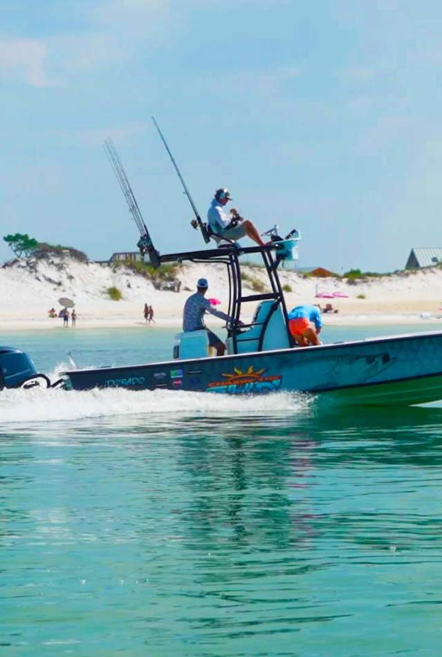 a boat sails near the beach
