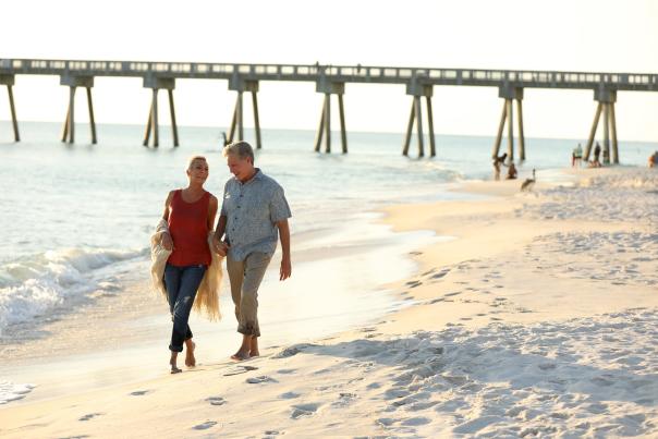 winter residents walk along the beach