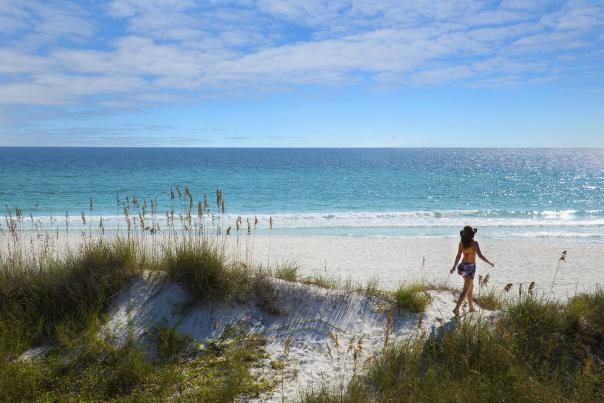 Girl on the beach sand dune