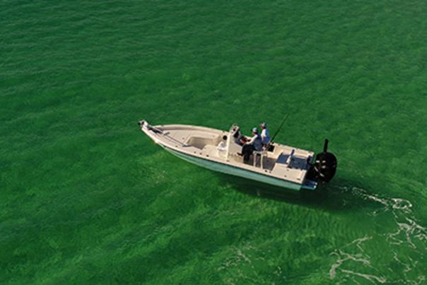 Fishermen on a boat navigate the crystal clear water near Panama City Beach